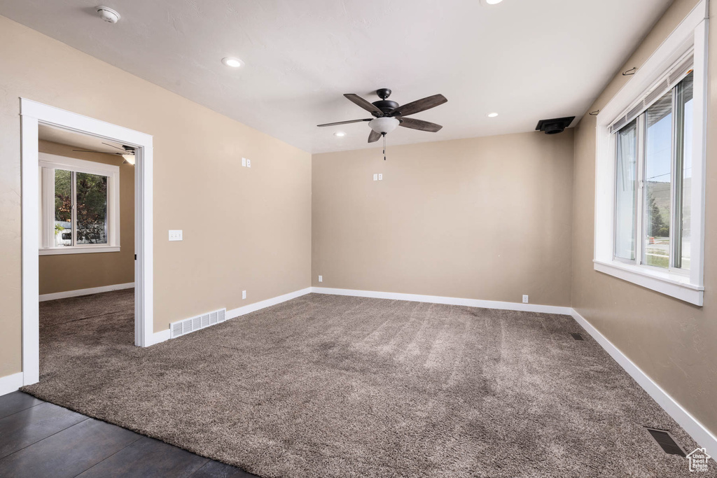 Spare room with ceiling fan, dark colored carpet, a smoke detector, baseboards, and recessed lighting