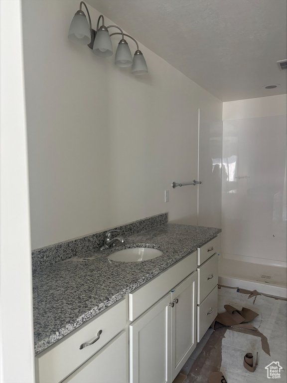 Full bath with walk in shower and vanity
