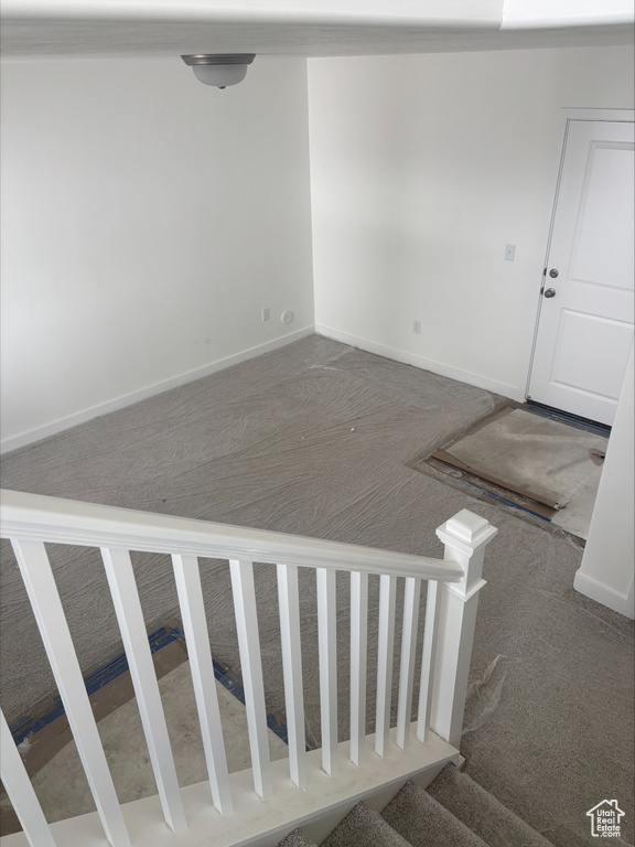 Staircase with baseboards and carpet