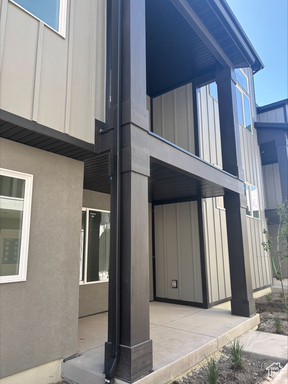 View of side of property featuring board and batten siding and stucco siding