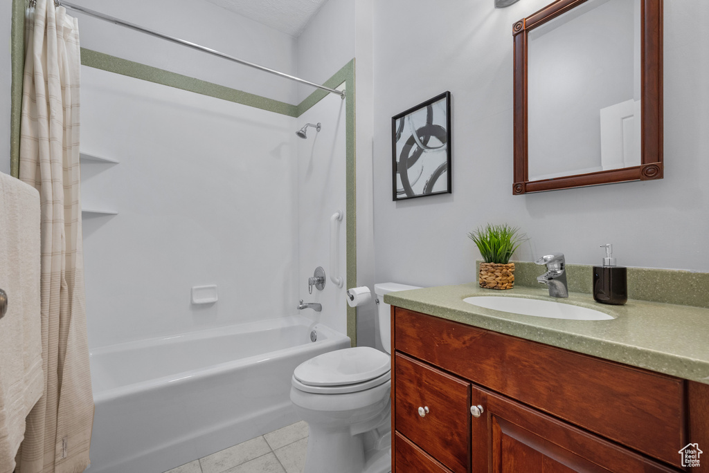 Full bath featuring shower / bathtub combination with curtain, vanity, toilet, and tile patterned floors