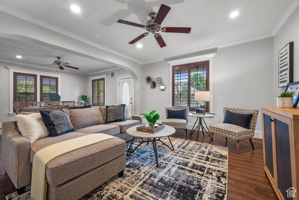 Living room featuring arched walkways, a ceiling fan, wood finished floors, plenty of natural light, and recessed lighting