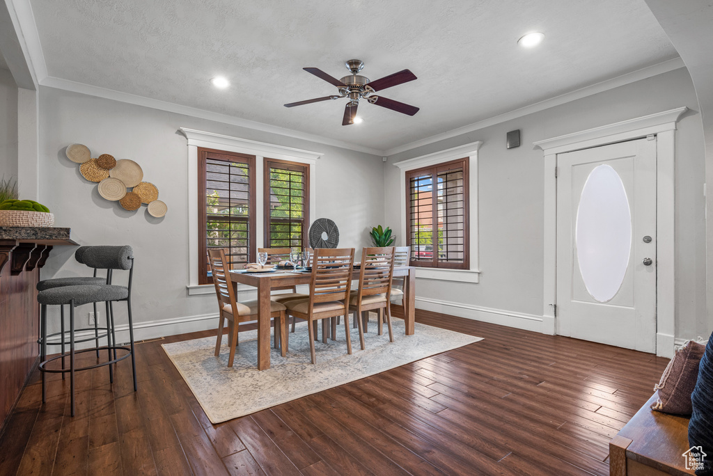 Dining room featuring ceiling fan, hardwood / wood-style floors, baseboards, recessed lighting, and crown molding