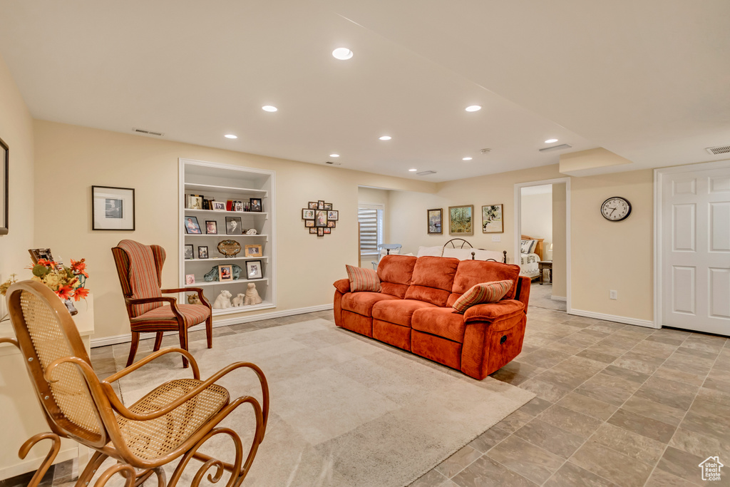 Living area featuring baseboards, recessed lighting, visible vents, and built in shelves