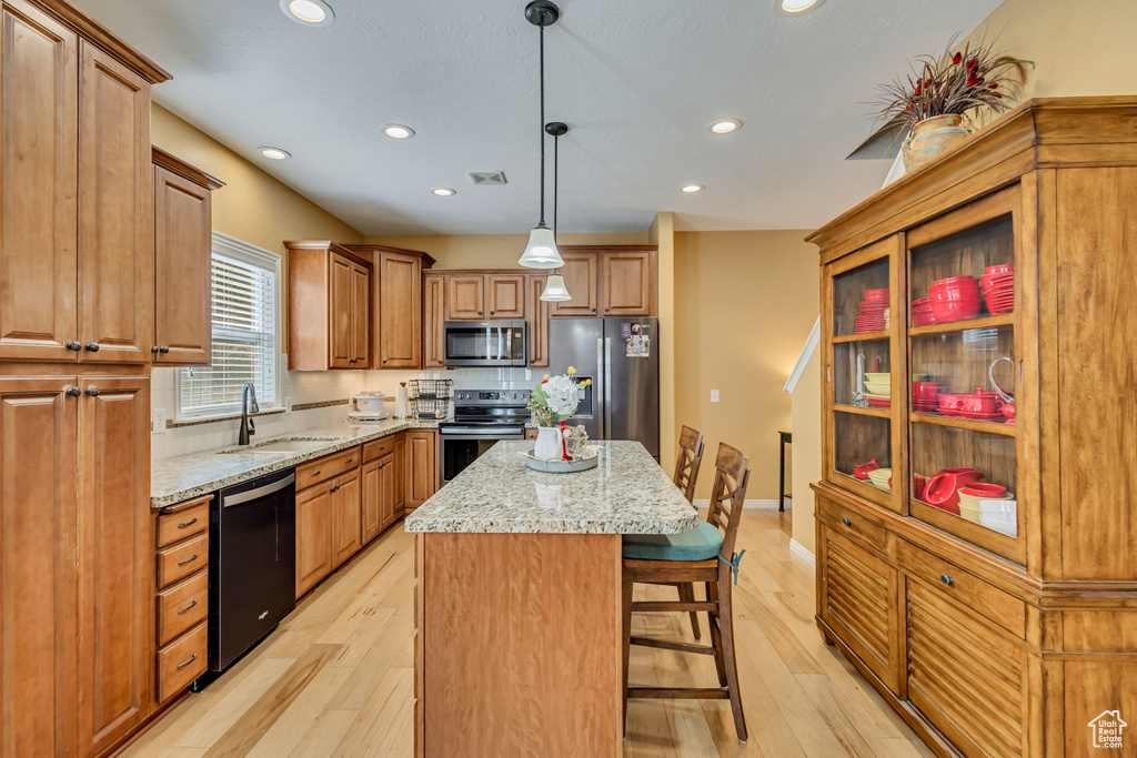 Kitchen featuring a center island, stainless steel appliances, recessed lighting, and a sink