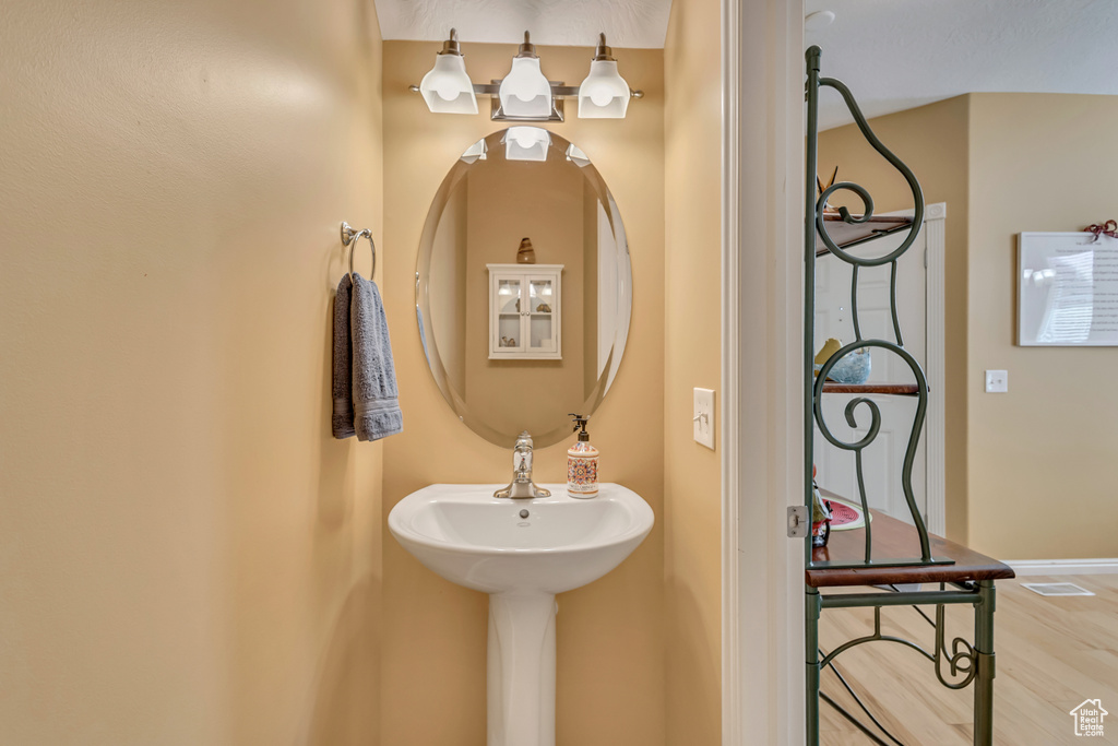 Bathroom featuring wood finished floors and baseboards