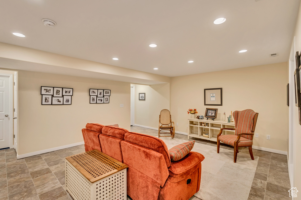 Living area with stone finish floor, recessed lighting, and baseboards