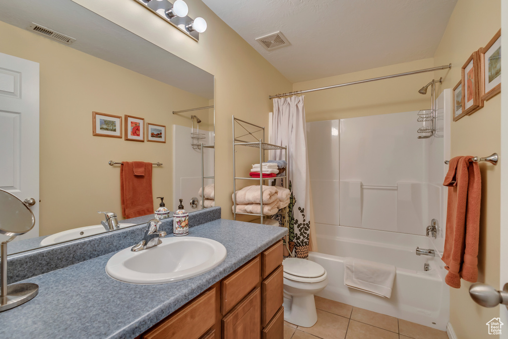 Full bath with toilet, tile patterned flooring, visible vents, and vanity