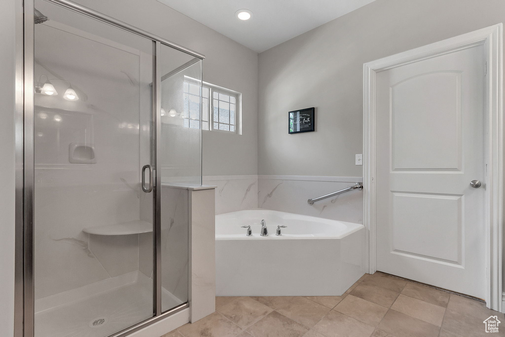 Full bath with a bath and a stall shower