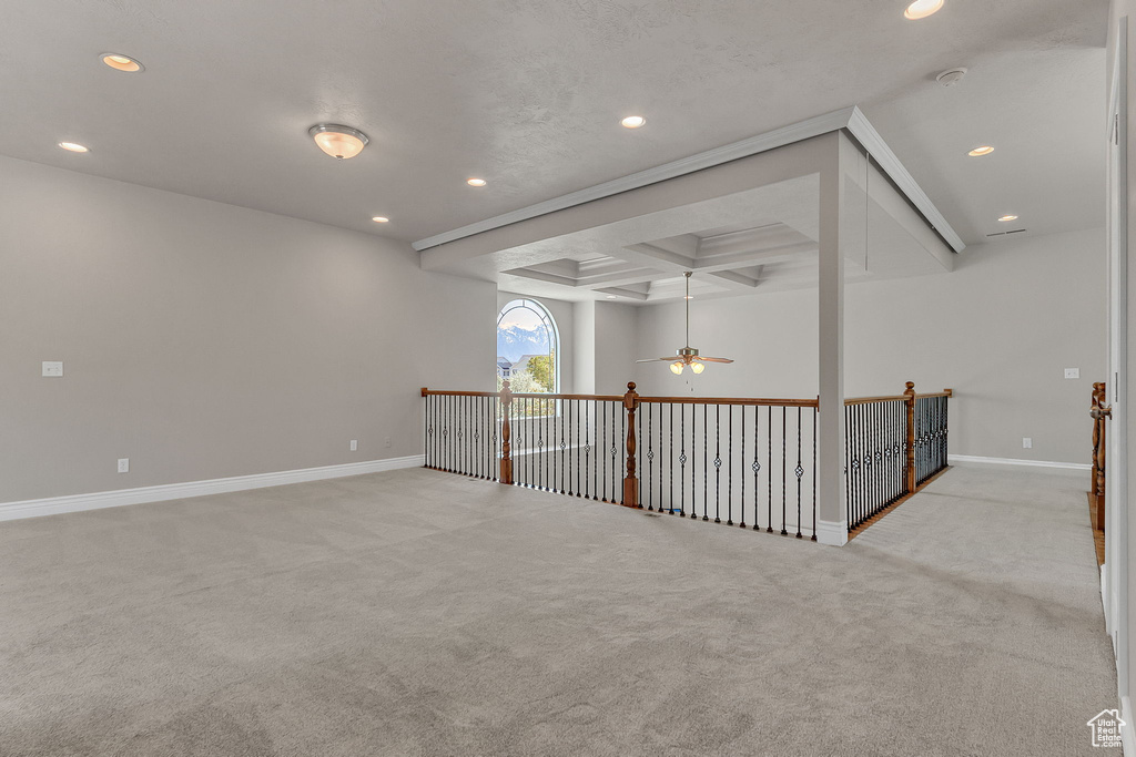 Carpeted empty room with recessed lighting, a ceiling fan, coffered ceiling, baseboards, and beam ceiling
