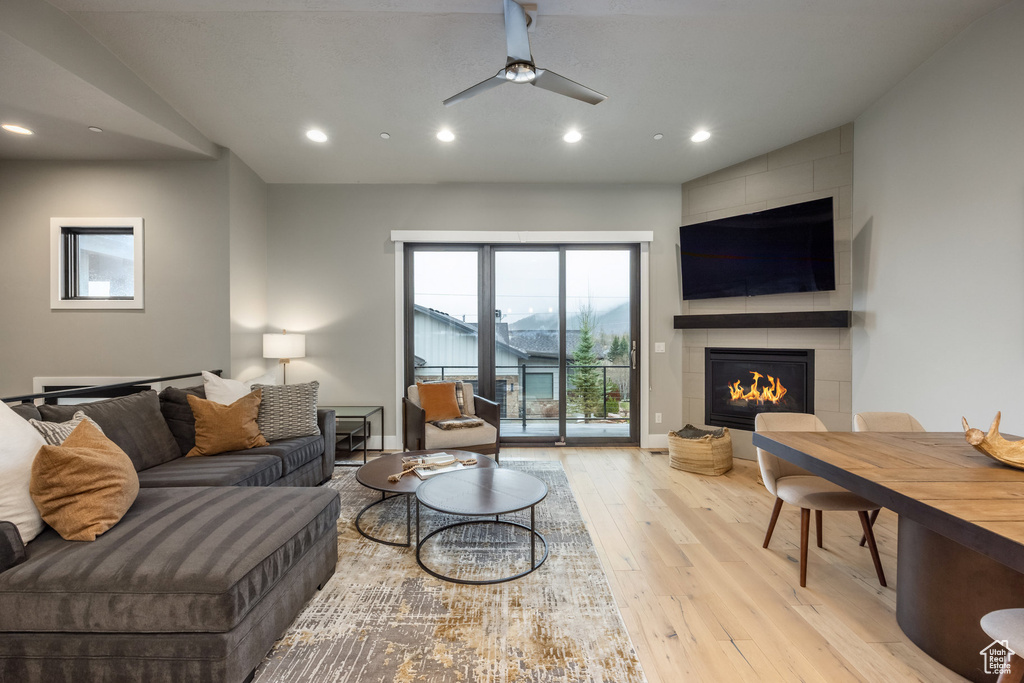 Living room with recessed lighting, a fireplace, and wood-type flooring