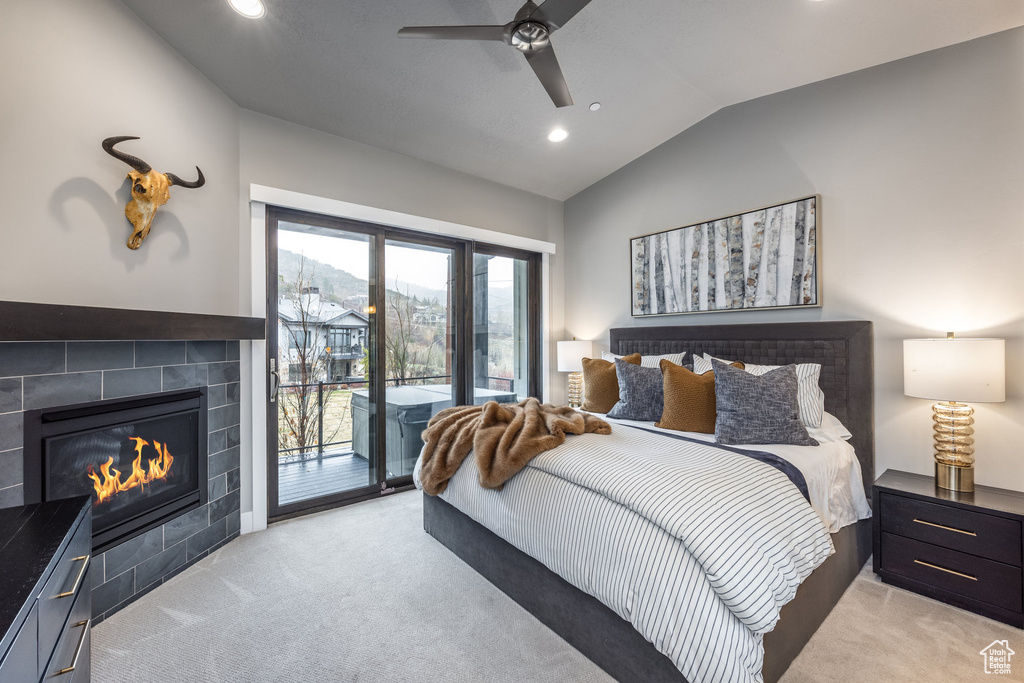 Bedroom with lofted ceiling, light colored carpet, recessed lighting, and access to outside