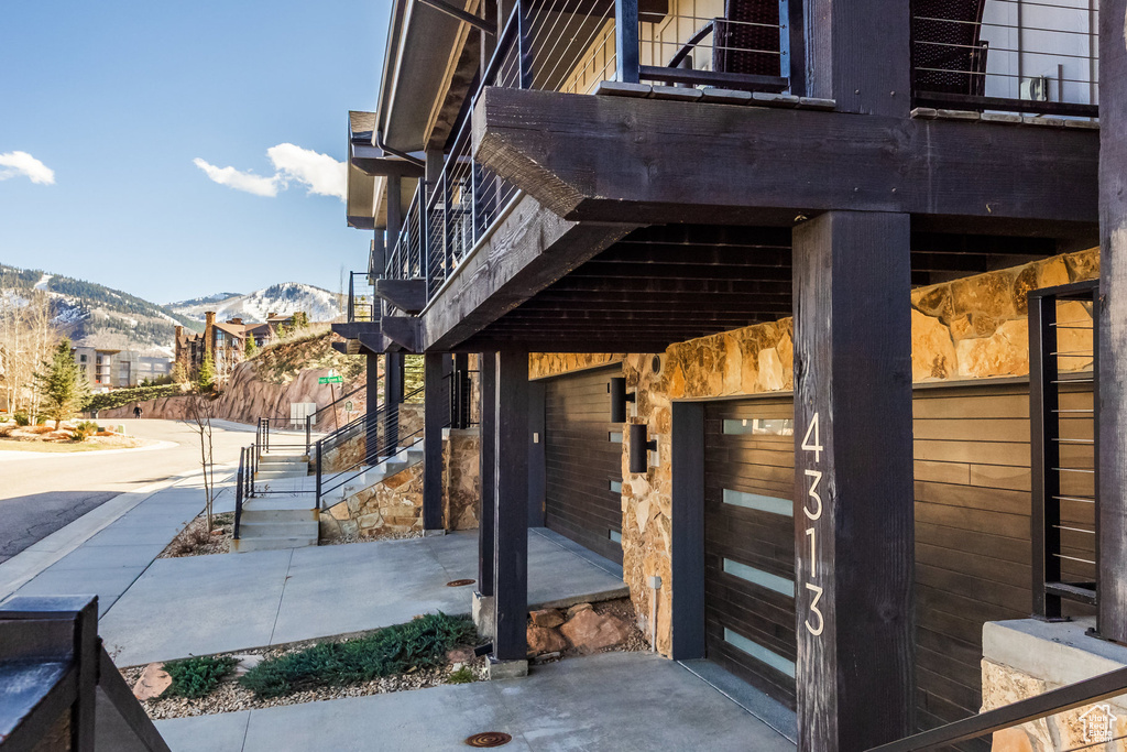Exterior space featuring stairway, a balcony, and a mountain view