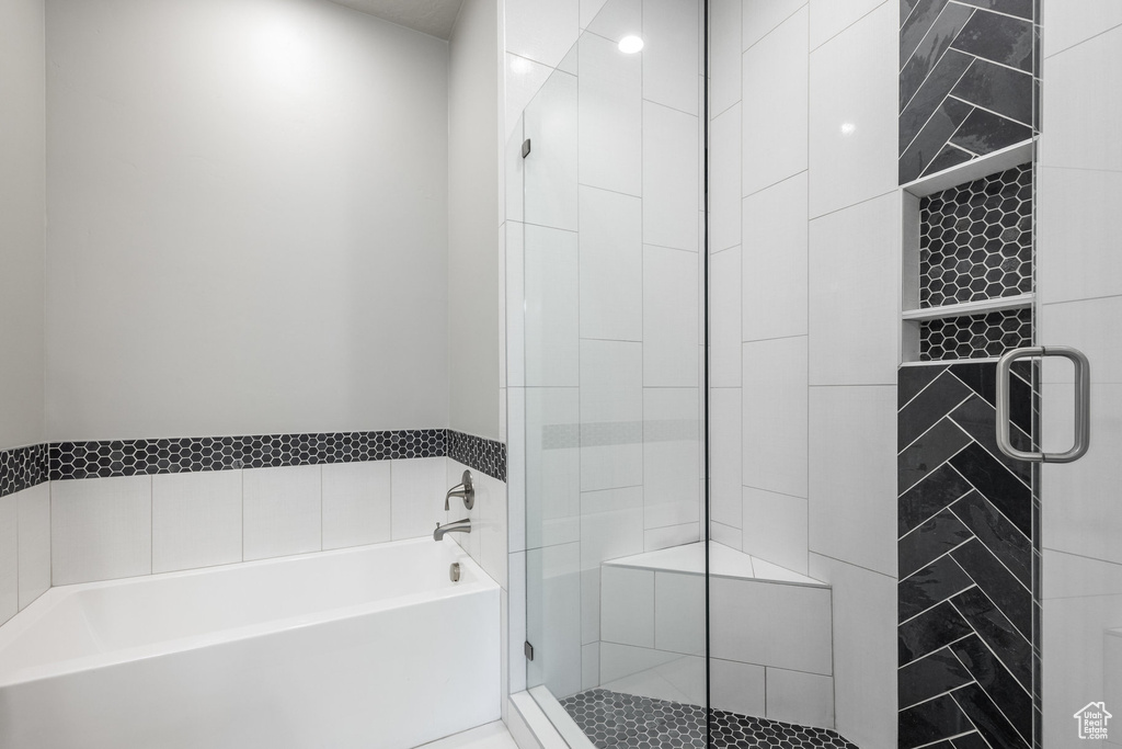 Bathroom featuring a bath and a stall shower