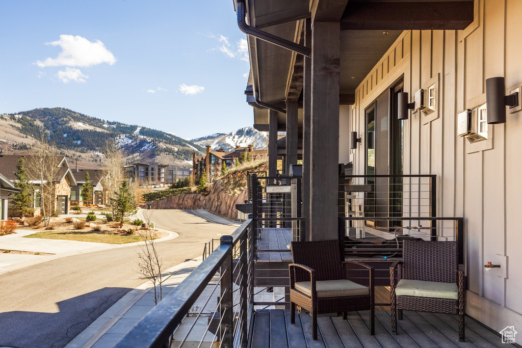 Balcony featuring a residential view and a mountain view