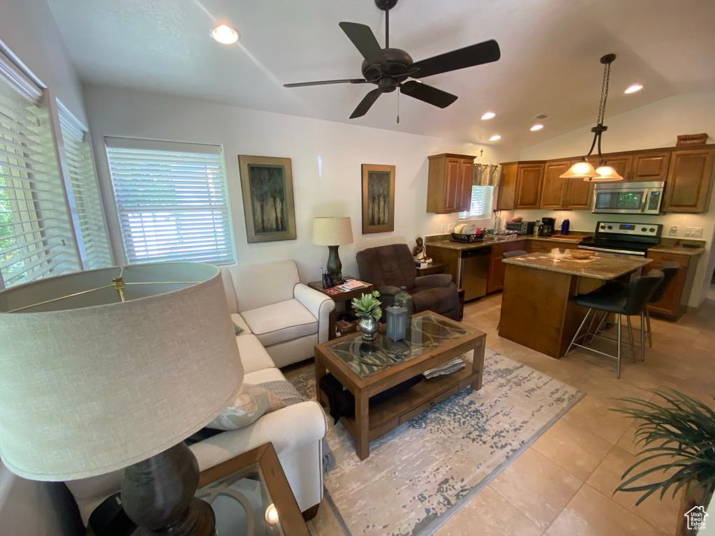 Living area with ceiling fan, recessed lighting, and vaulted ceiling