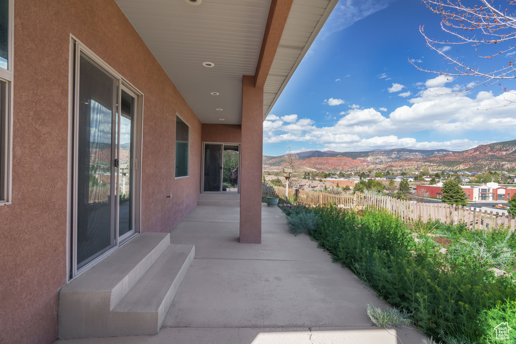 View of patio / terrace with a mountain view and fence