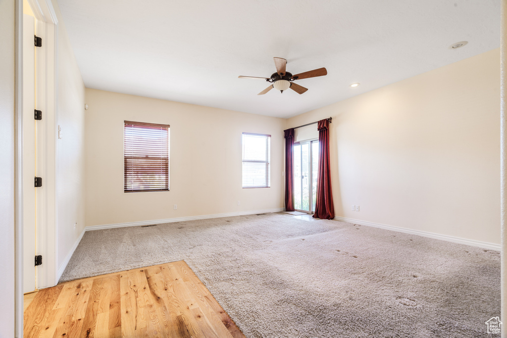 Spare room with recessed lighting, ceiling fan, light colored carpet, and baseboards