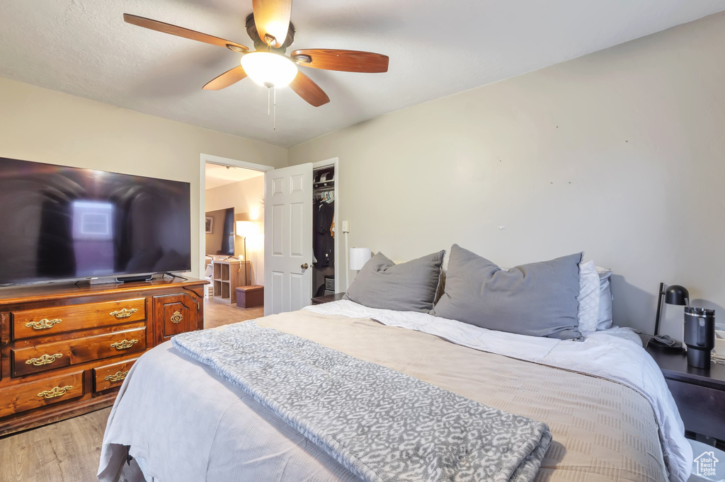Bedroom with wood finished floors and ceiling fan