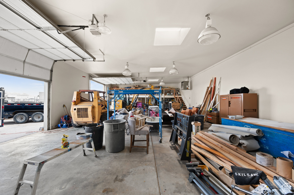 Garage featuring a workshop area and a garage door opener
