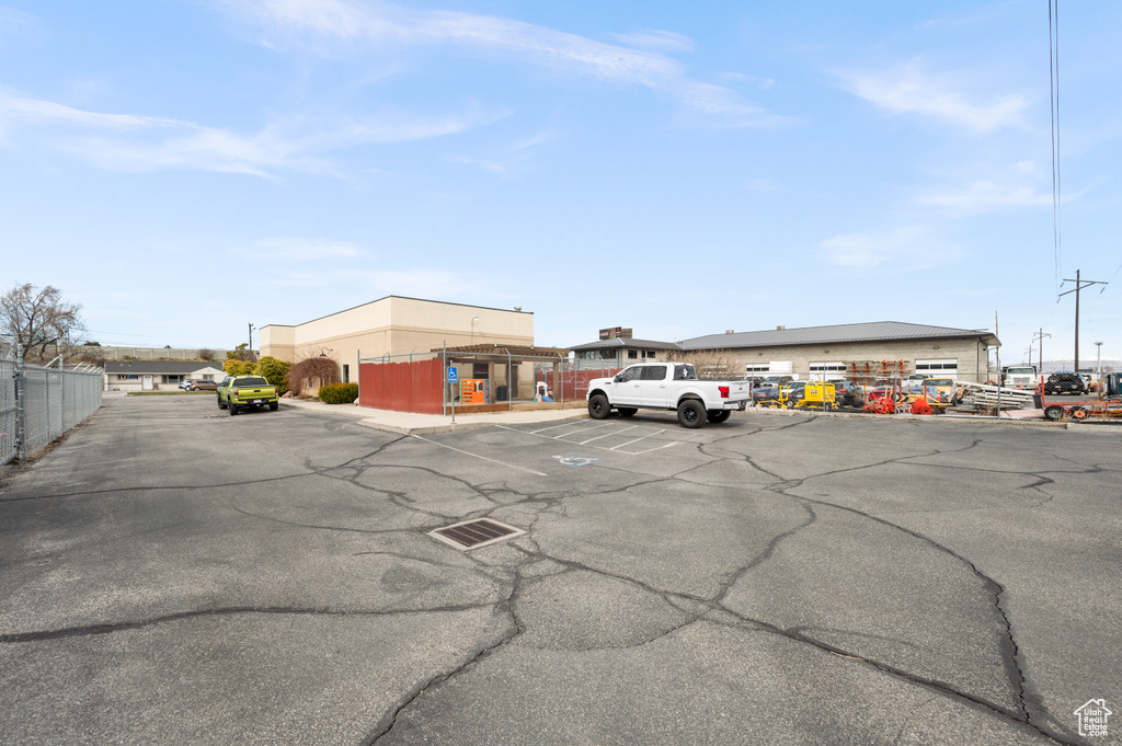 Uncovered parking lot featuring fence