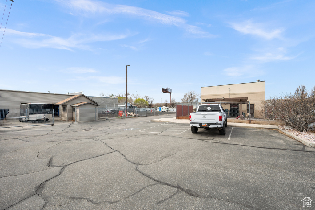 Uncovered parking lot featuring fence