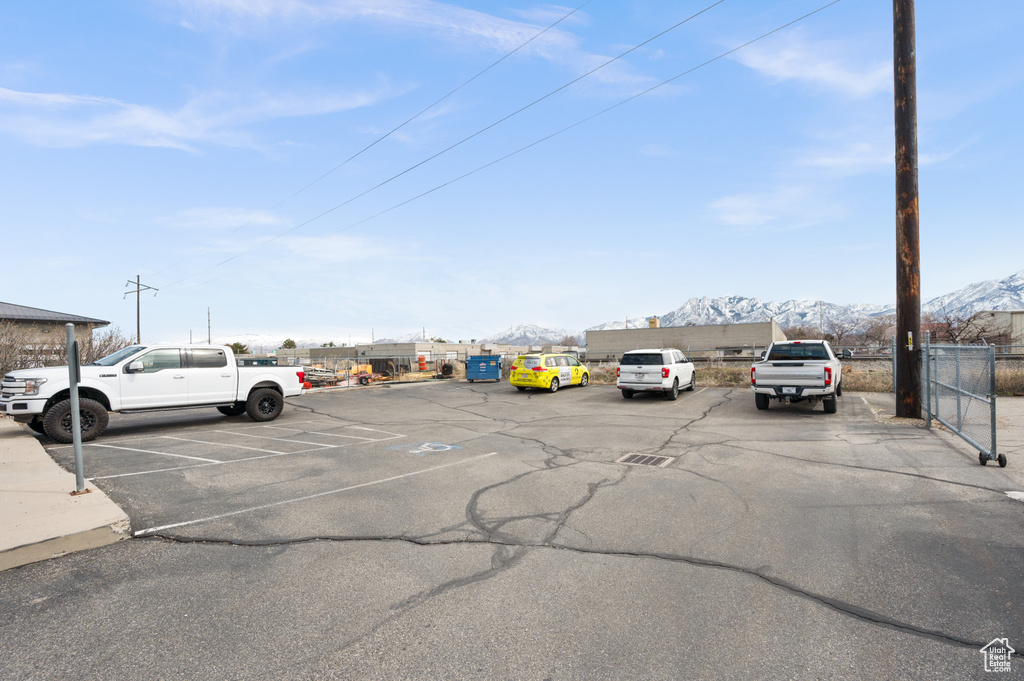Uncovered parking lot with fence and a mountain view