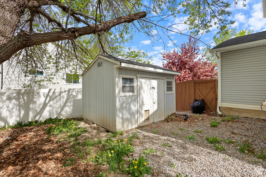 View of shed featuring fence