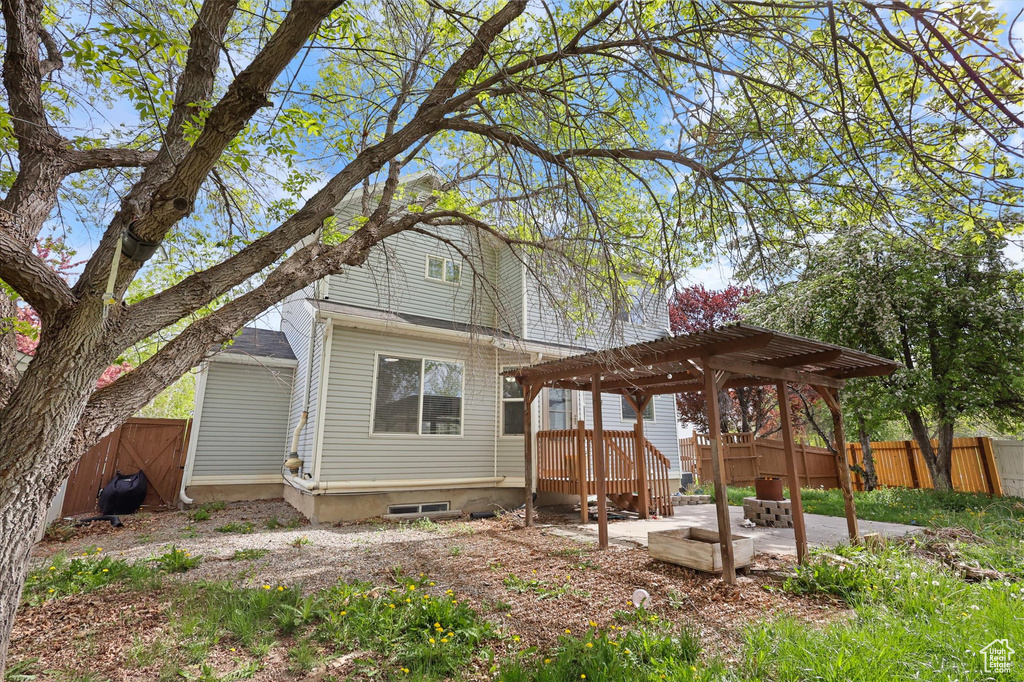 Back of house with a pergola, a patio area, and fence