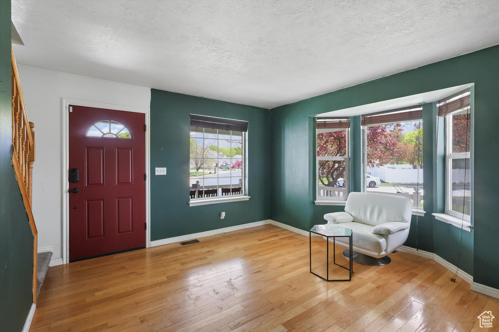 Entryway with visible vents, hardwood / wood-style flooring, a textured ceiling, and stairway