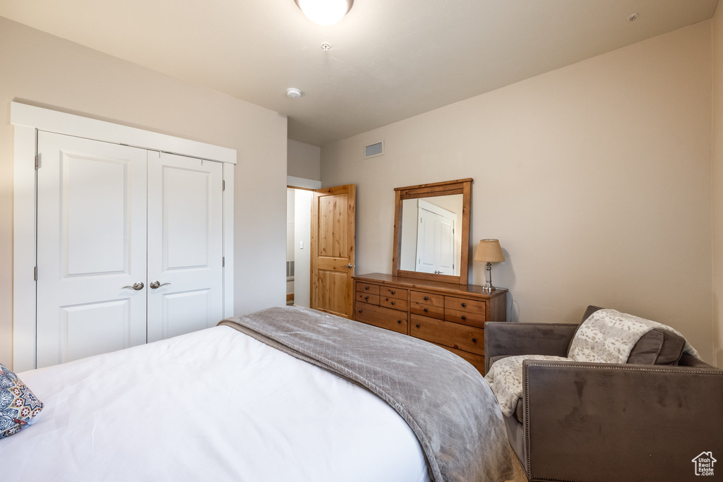 Bedroom featuring visible vents and a closet