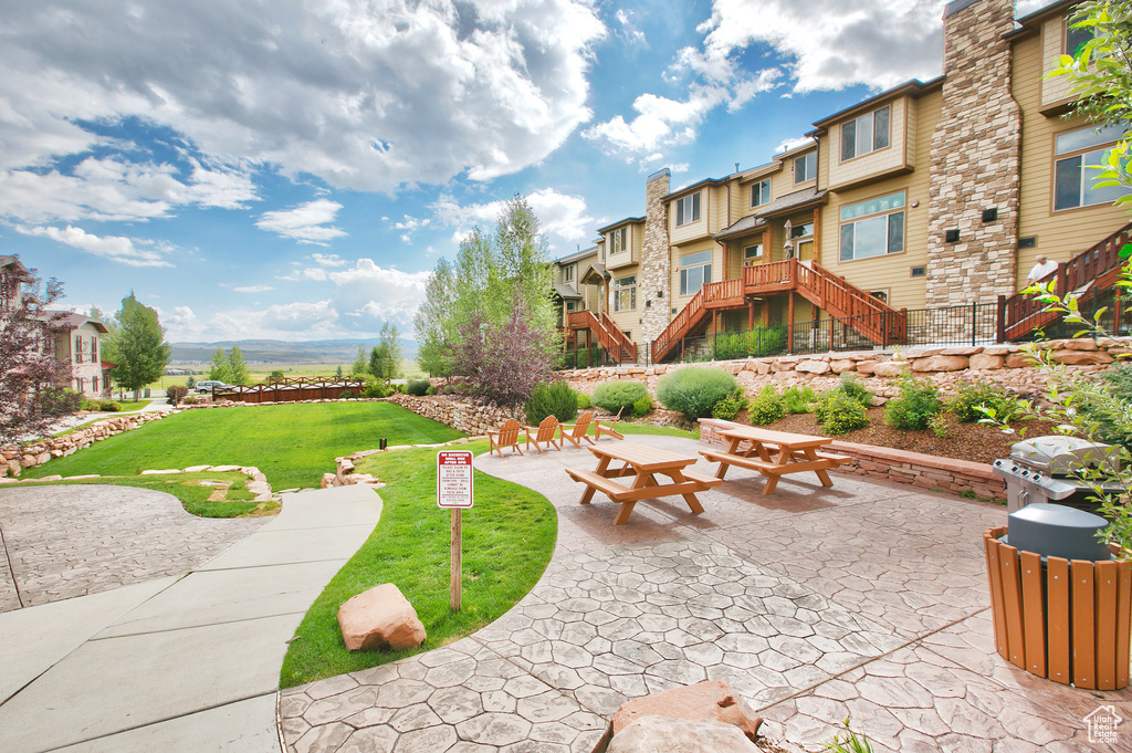 View of home's community with a lawn, stairway, and a residential view