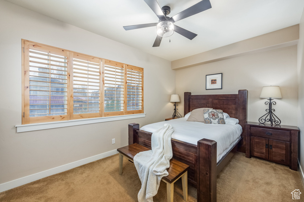 Bedroom with a ceiling fan, carpet, and baseboards