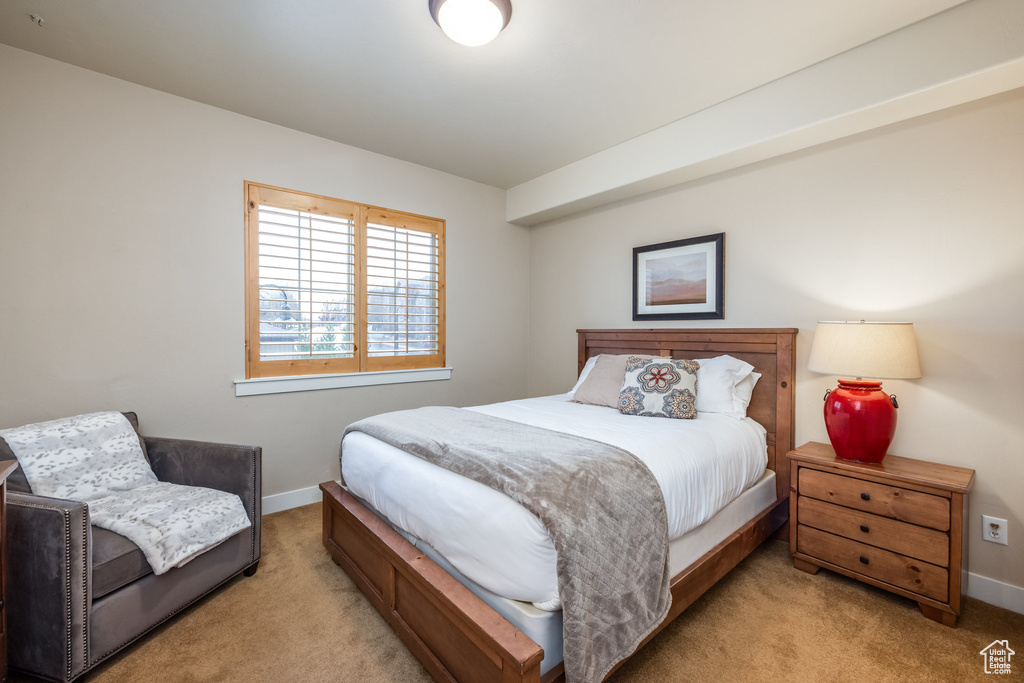 Bedroom featuring light colored carpet and baseboards