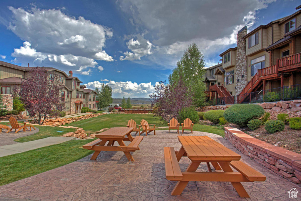 Surrounding community with a residential view and a patio area