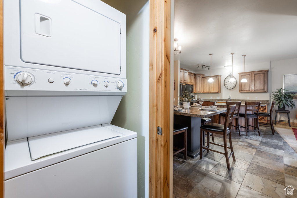 Laundry room with stacked washer / drying machine and laundry area