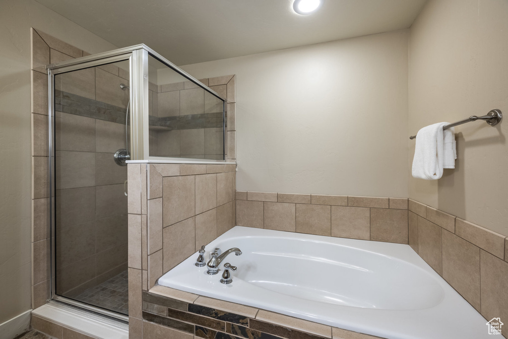 Full bath with a garden tub and a shower stall