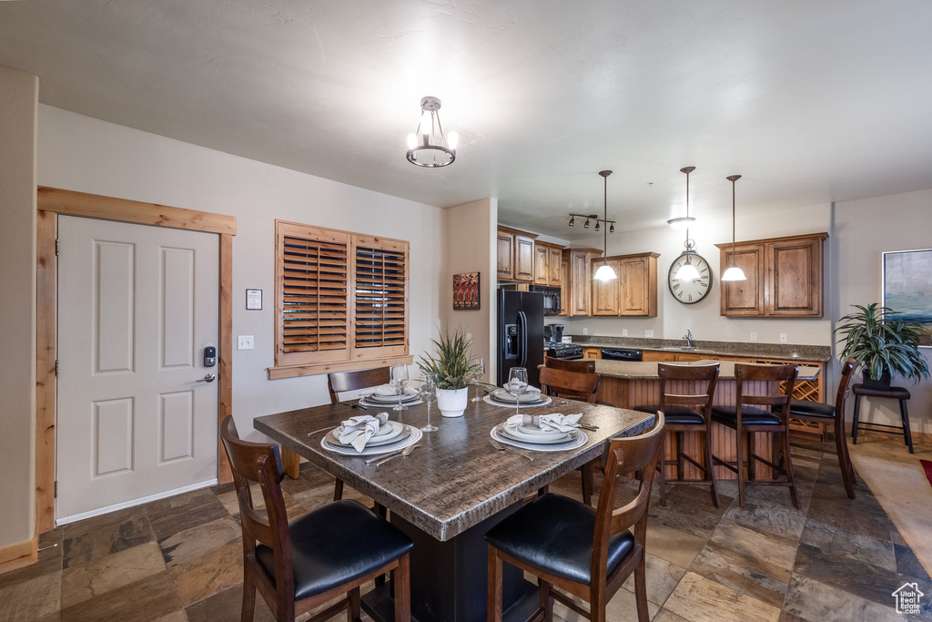 Dining room with stone tile floors and baseboards