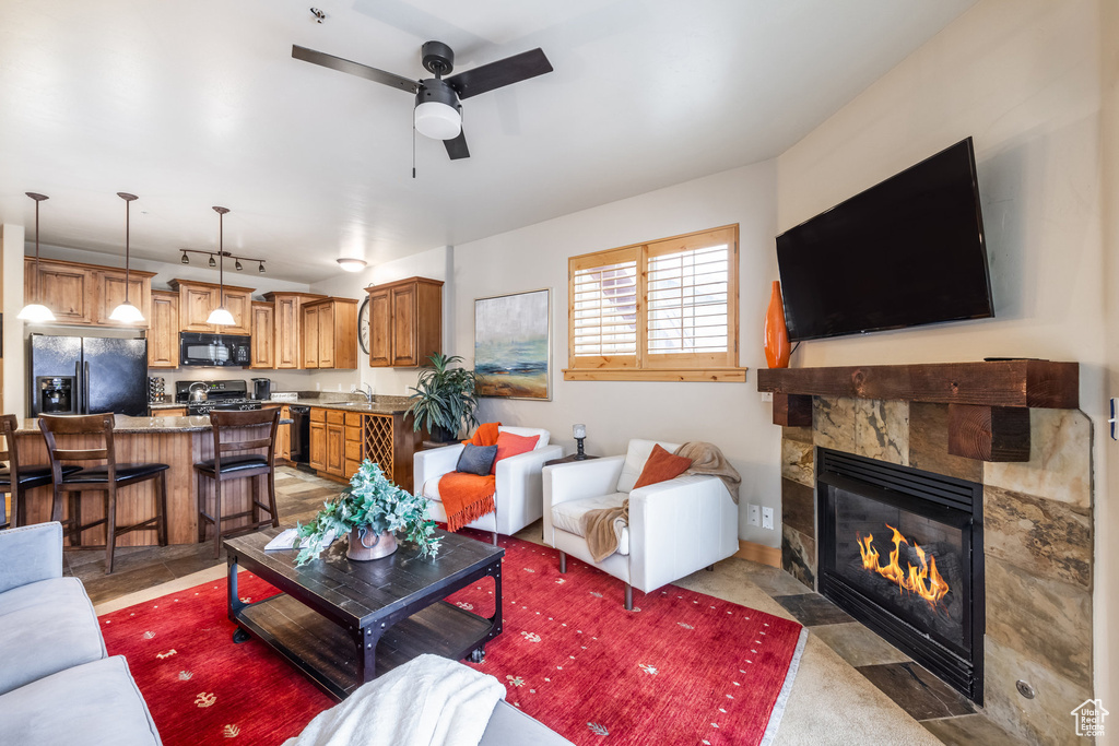 Living room featuring a fireplace and a ceiling fan