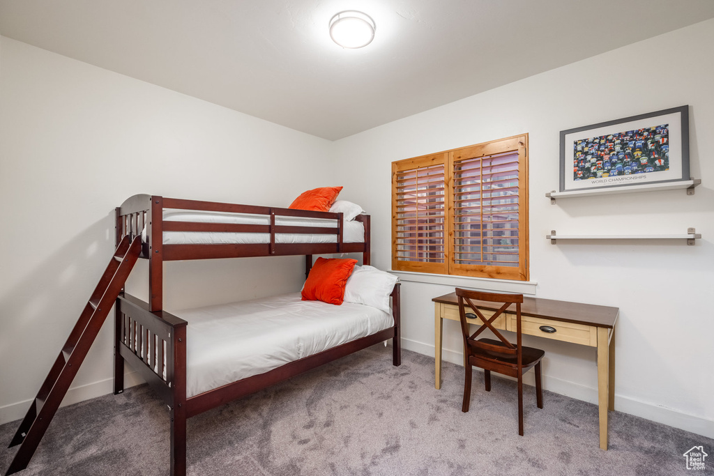Bedroom featuring baseboards and carpet floors