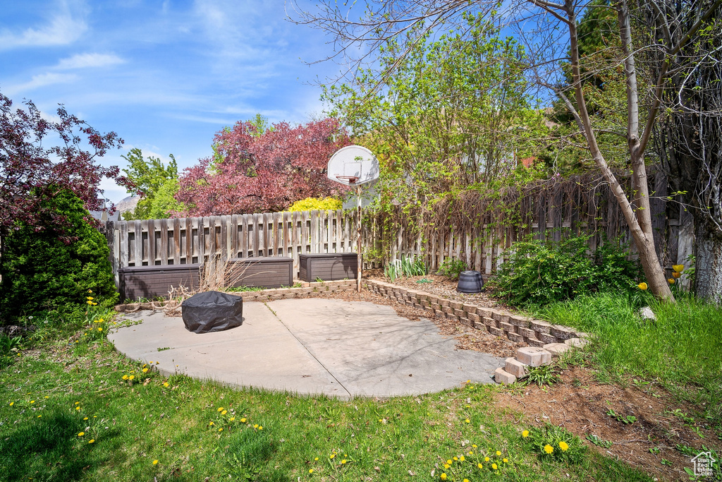 View of patio featuring a fire pit and fence