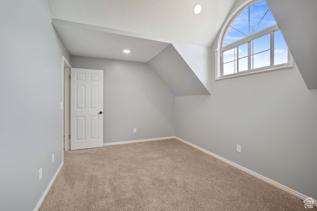 Additional living space featuring baseboards, recessed lighting, carpet floors, and lofted ceiling