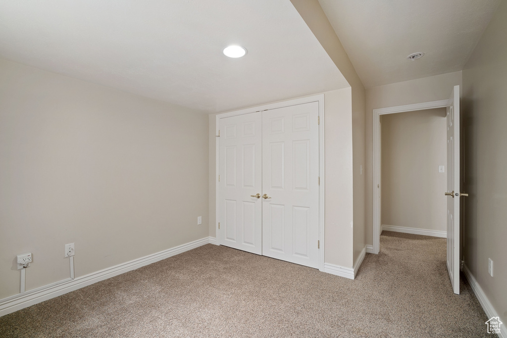 Unfurnished bedroom with carpet, baseboards, and a closet