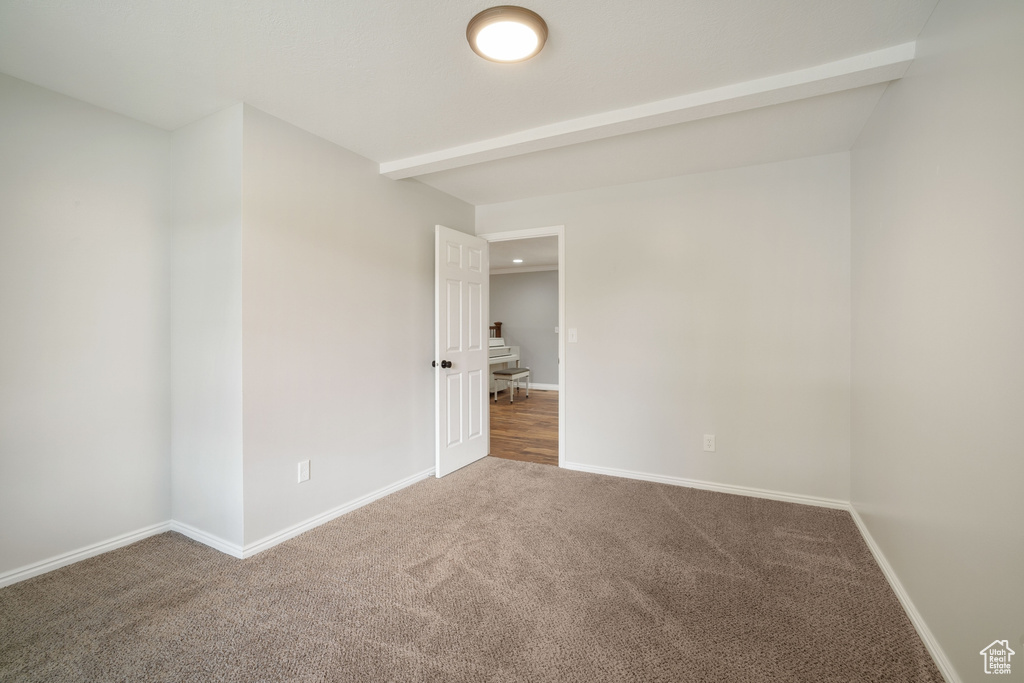 Empty room with baseboards and carpet floors