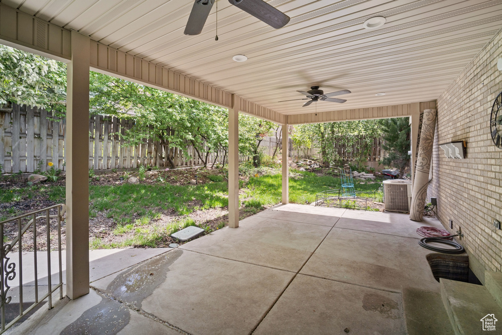 View of patio / terrace featuring central air condition unit, ceiling fan, and a fenced backyard