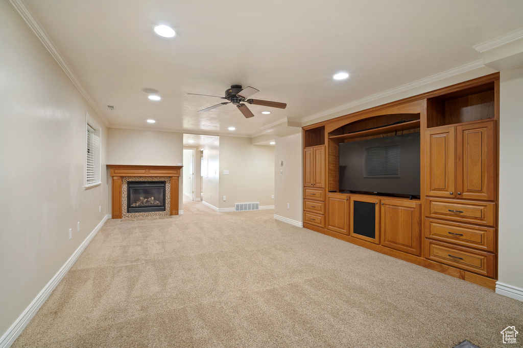 Unfurnished living room featuring visible vents, ceiling fan, baseboards, and light carpet
