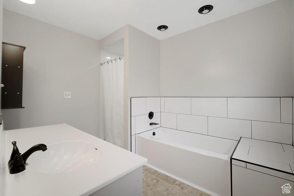 Bathroom with a bathing tub and a sink