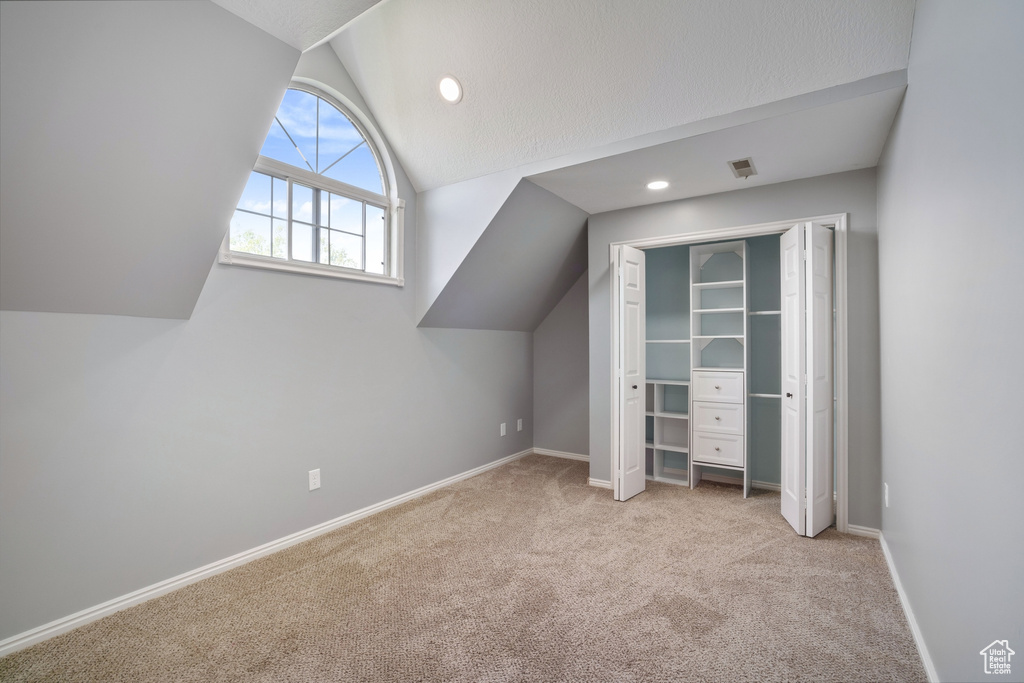 Bonus room with recessed lighting, carpet, vaulted ceiling, baseboards, and visible vents