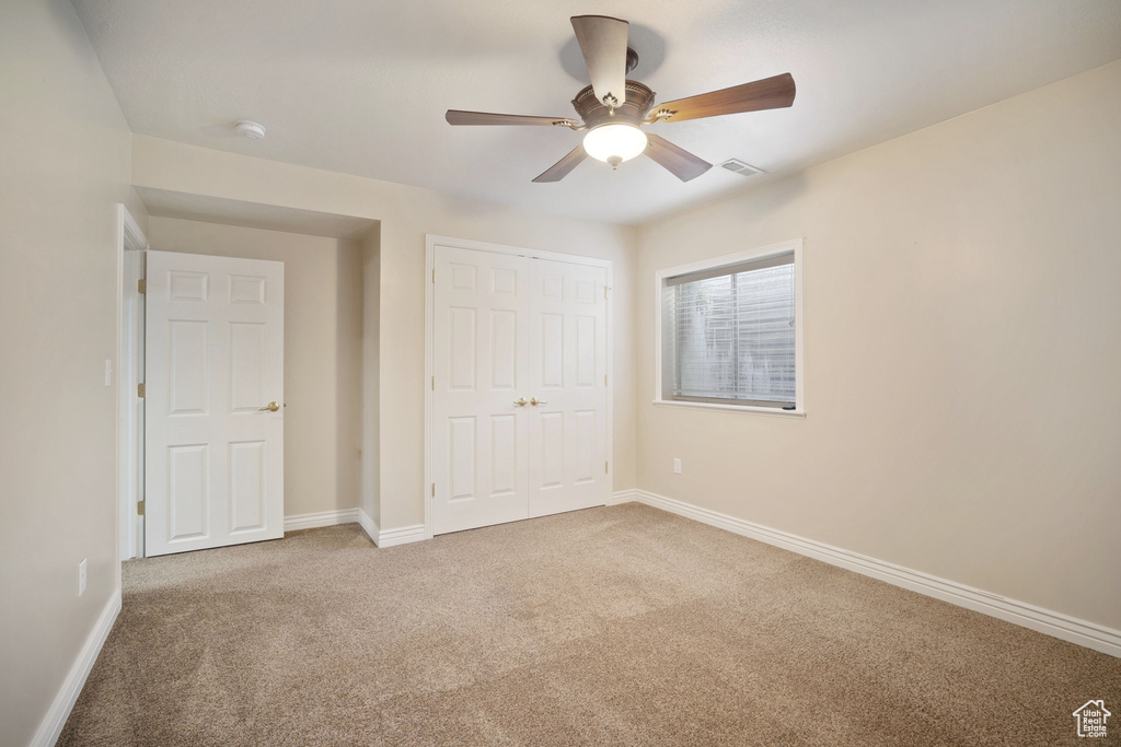 Unfurnished bedroom with baseboards, visible vents, and carpet