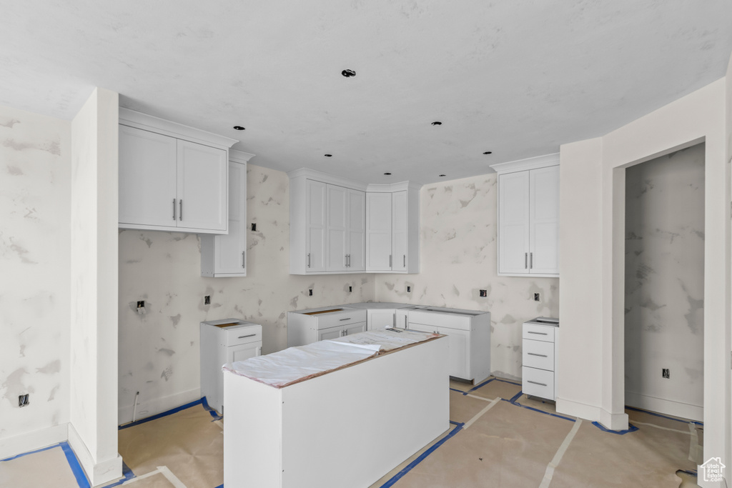 Clothes washing area featuring baseboards